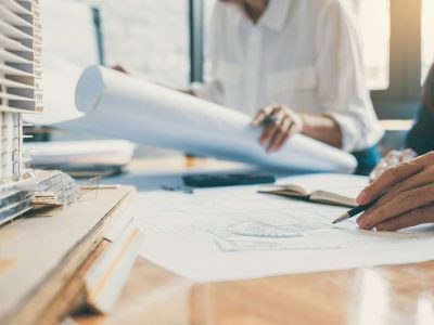 Team of Construction engineering or architect hands working on blueprint inspection in workplace